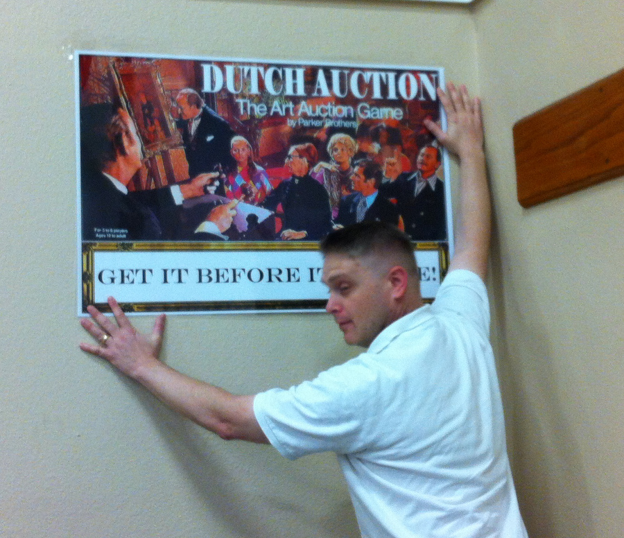 Dave hanging a poster