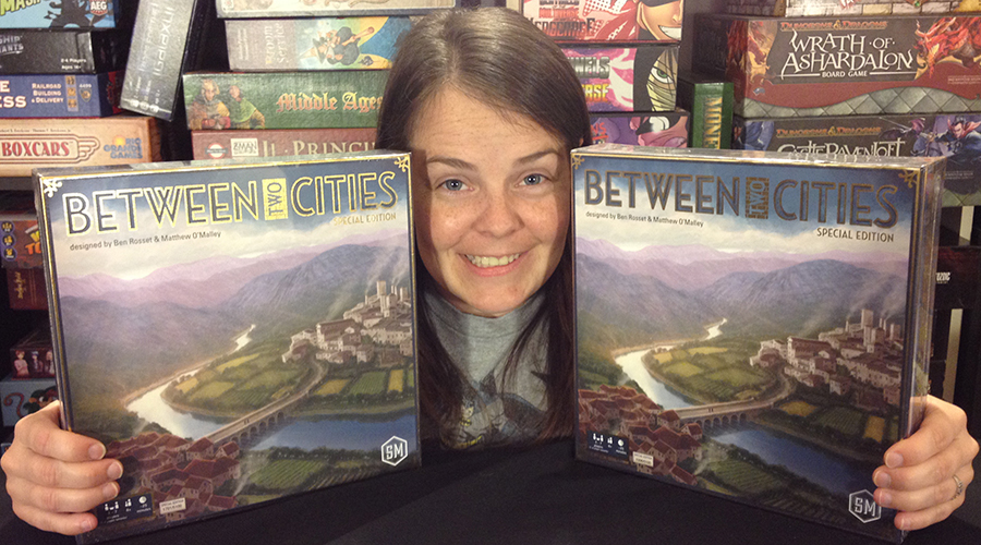 Molly holding 2 copies of Between Two Cities