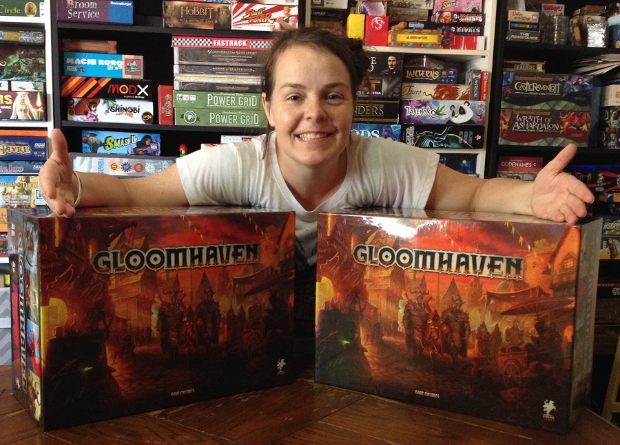 Molly showing Cephalofair Games' donations, two copies of gloomhaven